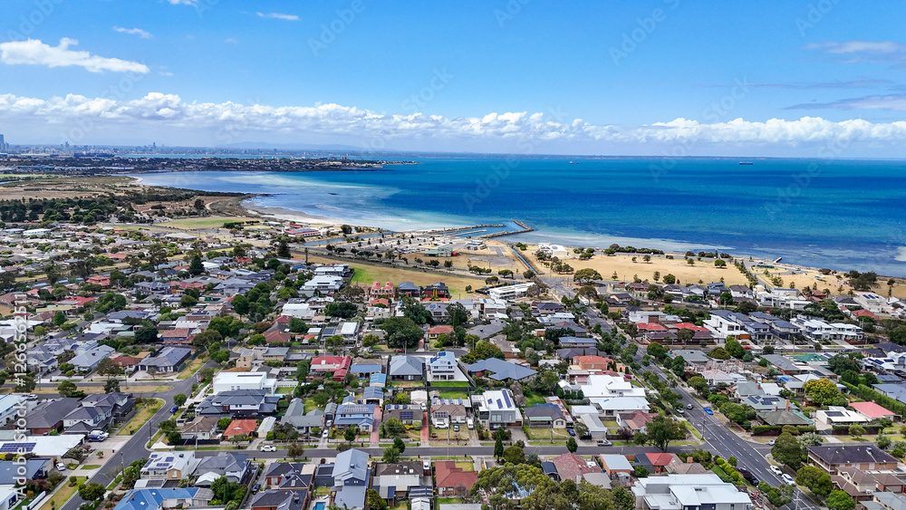 Aerial view of Seaholme, a bayside suburb of Melbourne Australia, featuring a beach, suburban residential neighborhood streets, and the beautiful coastline of Port Phillip Bay at western suburbs. Aerial view of Seaholme, a bayside suburb of Melbourne Australia, featuring a beach, suburban residential neighborhood streets, and the beautiful coastline of Port Phillip Bay at western suburbs.