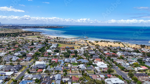 Aerial view of Seaholme, a bayside suburb of Melbourne Australia, featuring a beach, suburban residential neighborhood streets, and the beautiful coastline of Port Phillip Bay at western suburbs. photo