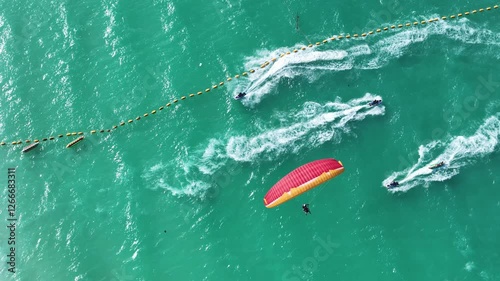 Paragliding in Thailand with blue sea. Two man paragliding high up in the sky. tourist attraction. Paraglider flies above the mountains in a bright sunny day