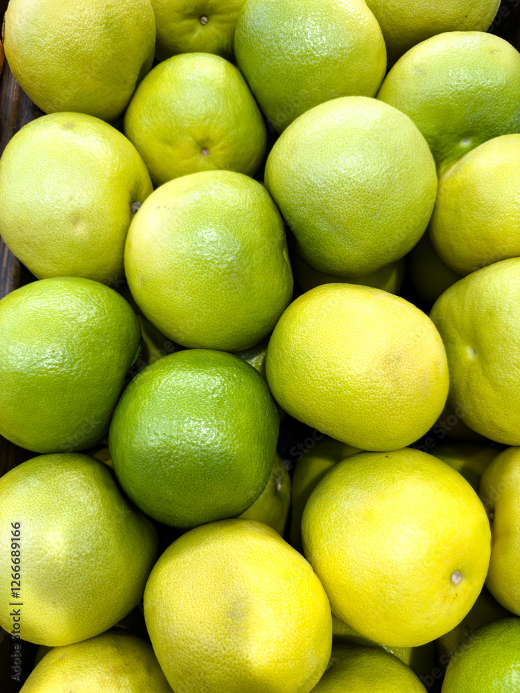 Fresh limes and lemons stacked together at a local market during the afternoon Fresh limes and lemons stacked together at a local market during the afternoon