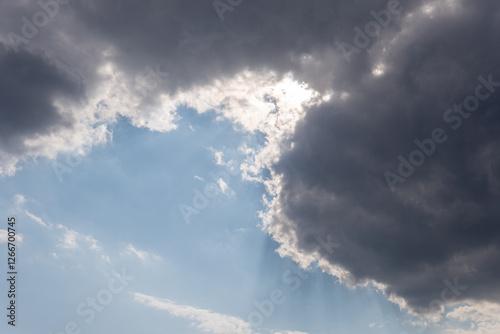 Fototapeta Naklejka Na Ścianę i Meble -  The sun is peeking through the clouds