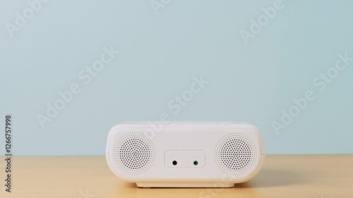 Girl putting a CD into a CD player or boombox. Person listening to music in a room.　CDプレイヤーまたはラジカセにCDを入れる女の子。部屋で音楽を聴く人。