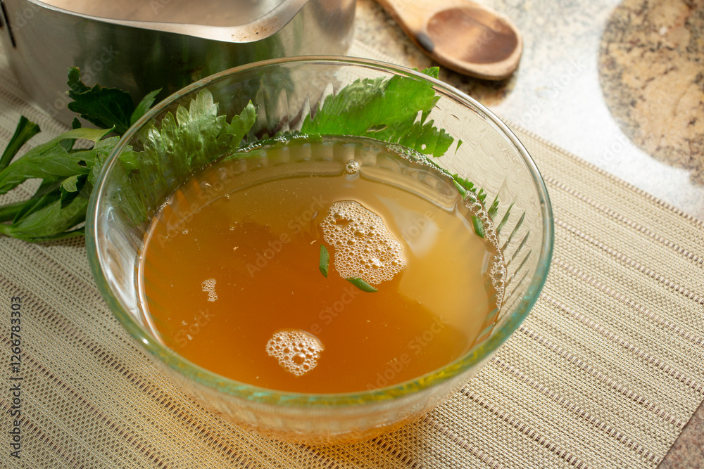 A view of a glass bowl filled with bone stock. A view of a glass bowl filled with bone stock.
