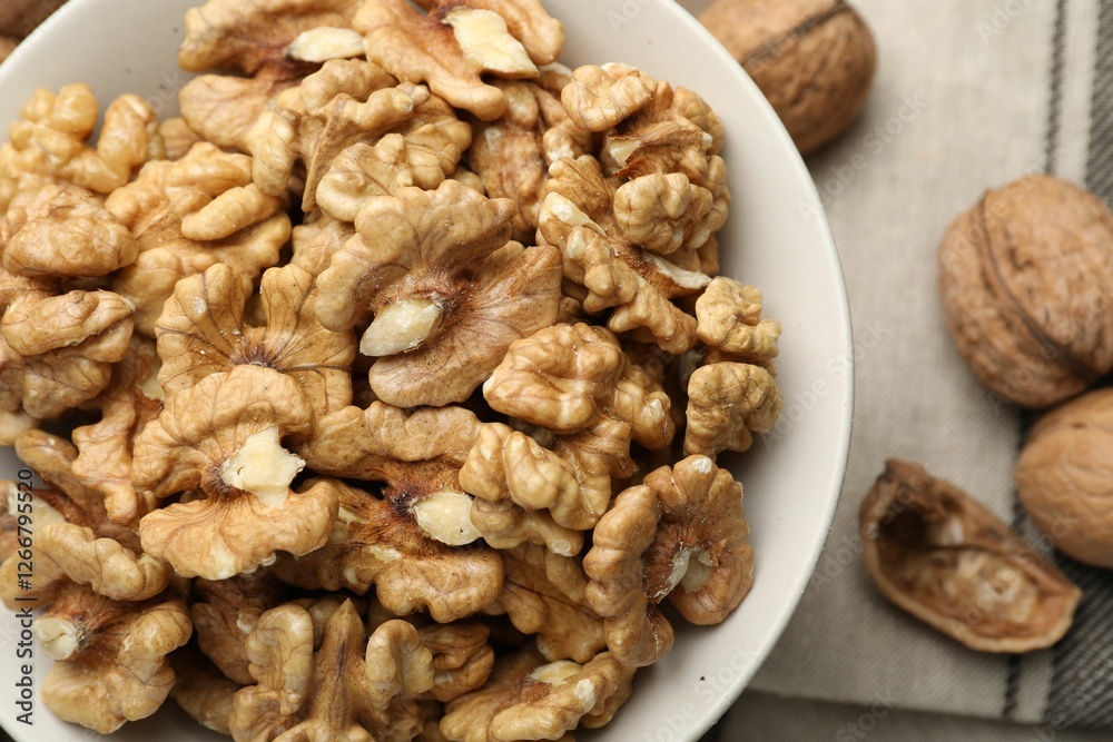 Peeled walnuts in bowl on table, top view Peeled walnuts in bowl on table, top view