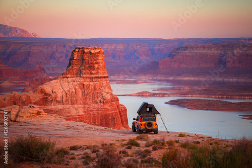 Yellow Truck Rooftop Tent Camping Overlooking a Desert Lake at Sunset photo