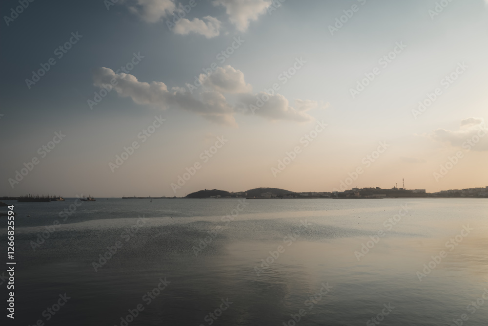 Tranquil Sunset Over Water with Gentle Waves and Clouds Tranquil Sunset Over Water with Gentle Waves and Clouds