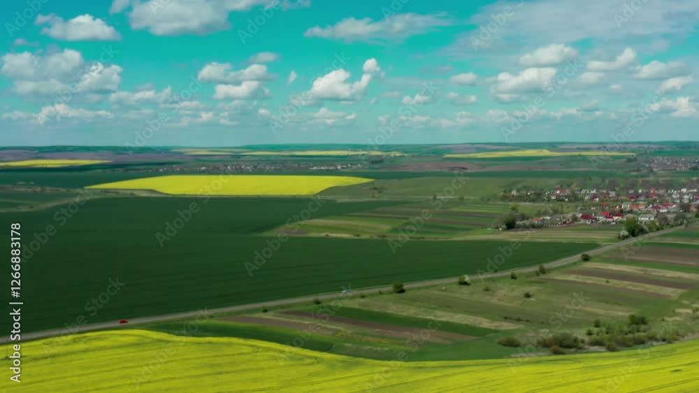 Rapeseed fields in full bloom, stretching across the horizon in vibrant shades of yellow. The breathtaking views highlight the natural beauty, agricultural charm and peaceful rural landscape Rapeseed fields in full bloom, stretching across the horizon in vibrant shades of yellow. The breathtaking views highlight the natural beauty, agricultural charm and peaceful rural landscape