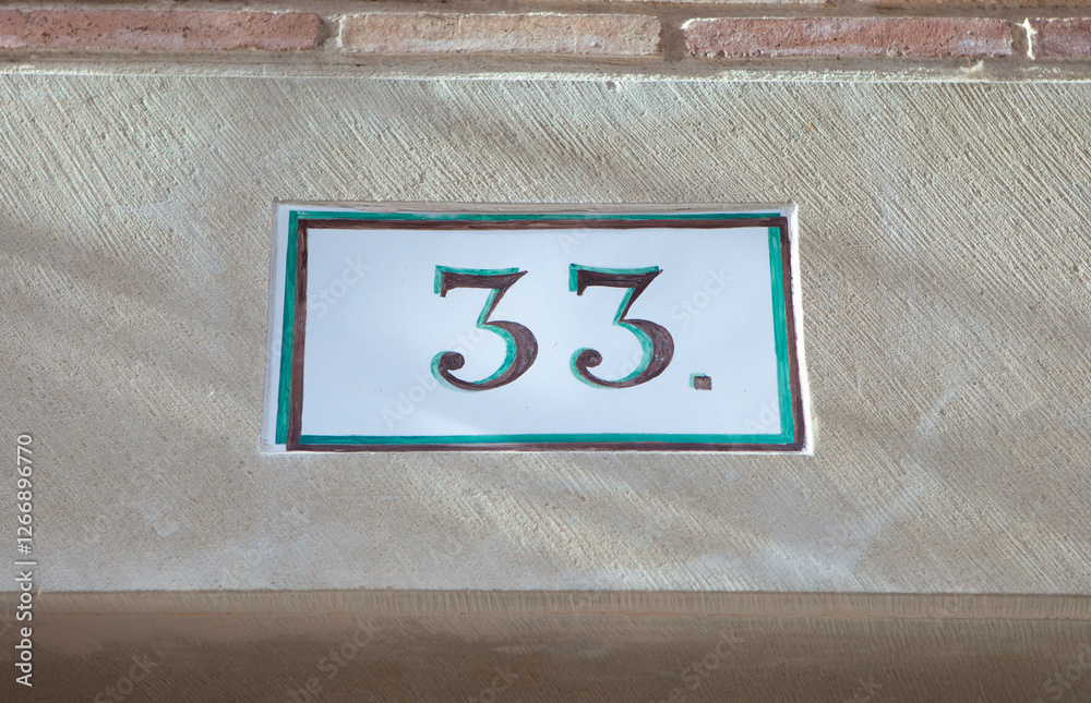 House number 33 thirty three. Houses numbers with personality at Estella, Navarre, Spain