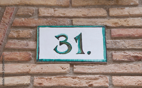 House number 31 thirty one. Houses numbers with personality at Estella, Navarre, Spain photo