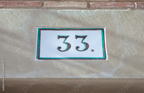 Obraz na płótnie House number 33 thirty three. Houses numbers with personality at Estella, Navarre, Spain w salonie