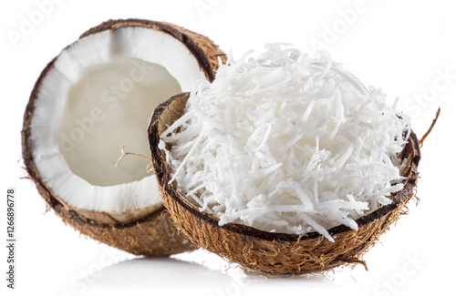 Obraz na plátně Grated coconut pulp in cracked coconut shell and half of split coconut on white background
