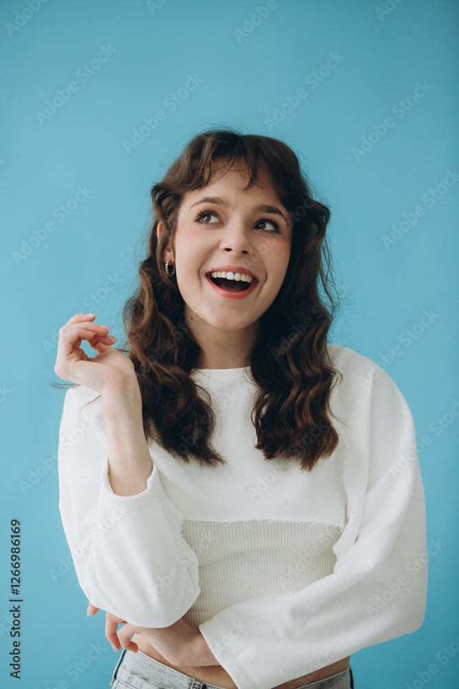 Portrait of a Cheerful Woman Smiling Against a Blue Background Portrait of a Cheerful Woman Smiling Against a Blue Background