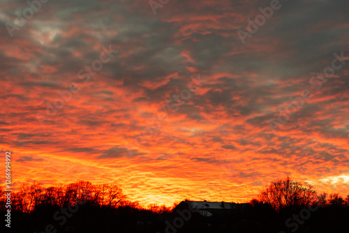 Fiery Sunset Over a Rural Horizon