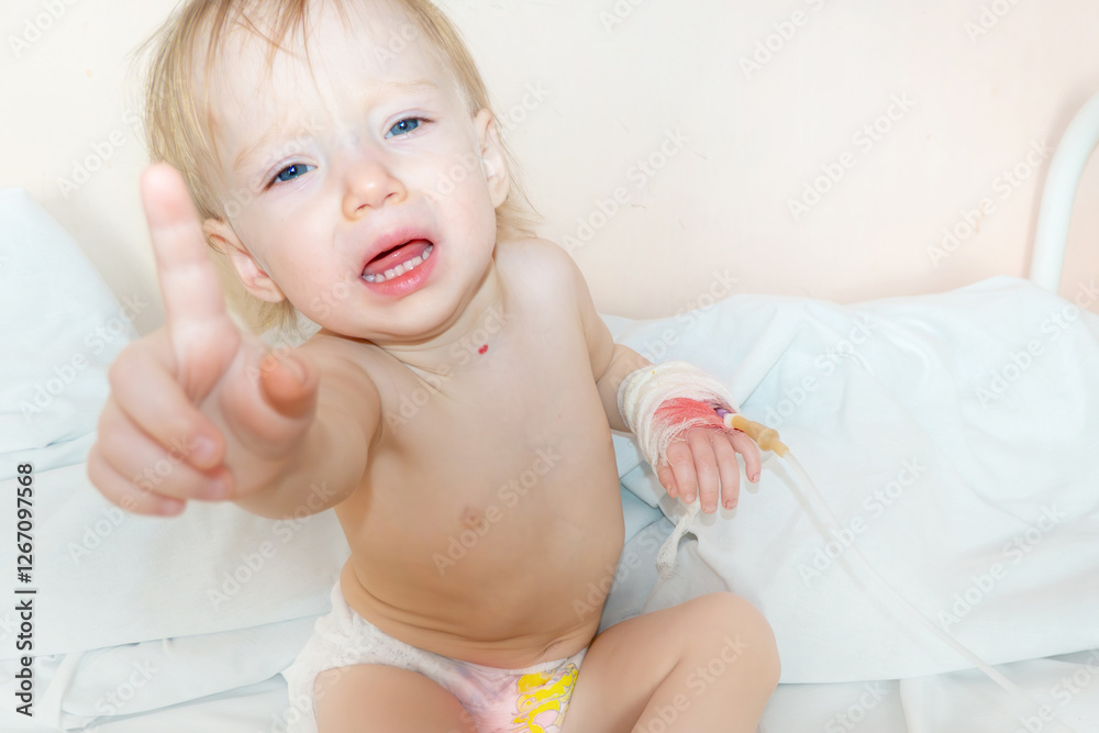 Children illness . Little Baby attaching intravenous tube to patient's hand in hospital bed. Baby sick and crying and baby want mom