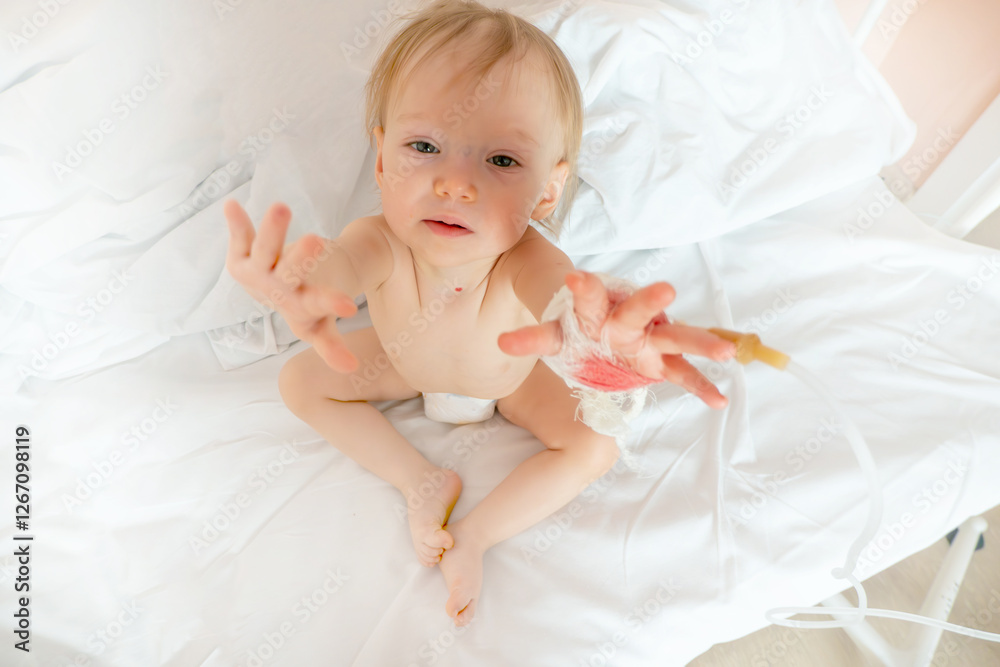 Children illness . Little Baby attaching intravenous tube to patient's hand in hospital bed. Baby sick and crying and baby want mom