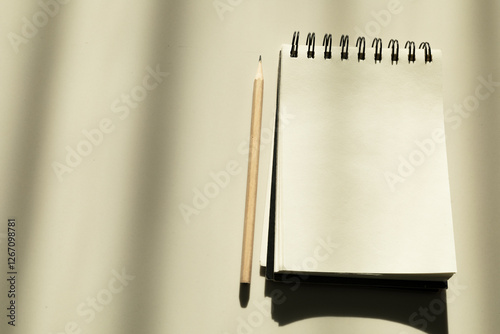 Notebook and pencil on white background Used for taking notes in every form of daily life.