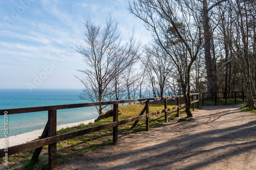 Cliffside Walking Path with Wooden Fence Overlooking the Sea in Jastrzębia Góra