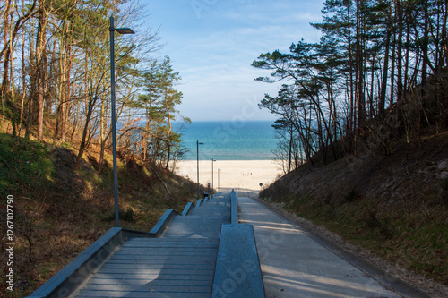 Scenic Stairway Leading to a Sandy Beach with Blue Sea and Sky in Jastrzębia Góra
