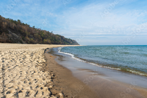 Sandy Beach and Cliffs with Waves in Jastrzębia Góra on a Sunny Spring Day