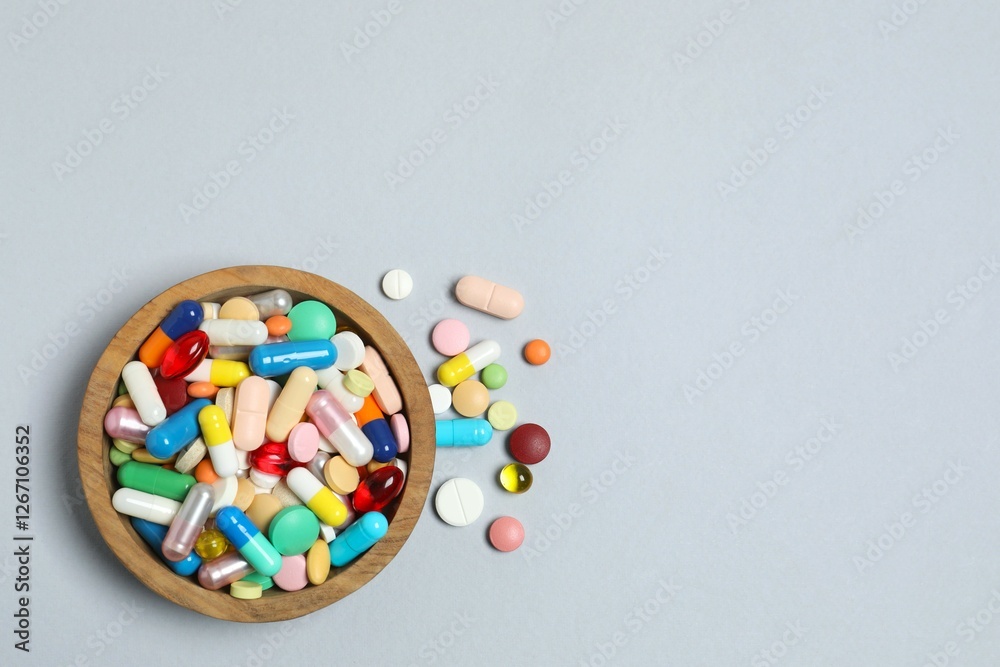 Various pills in a bowl on gray background Various pills in a bowl on gray background
