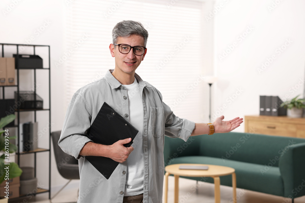 Fototapeta premium Portrait of professional psychologist with clipboard in office