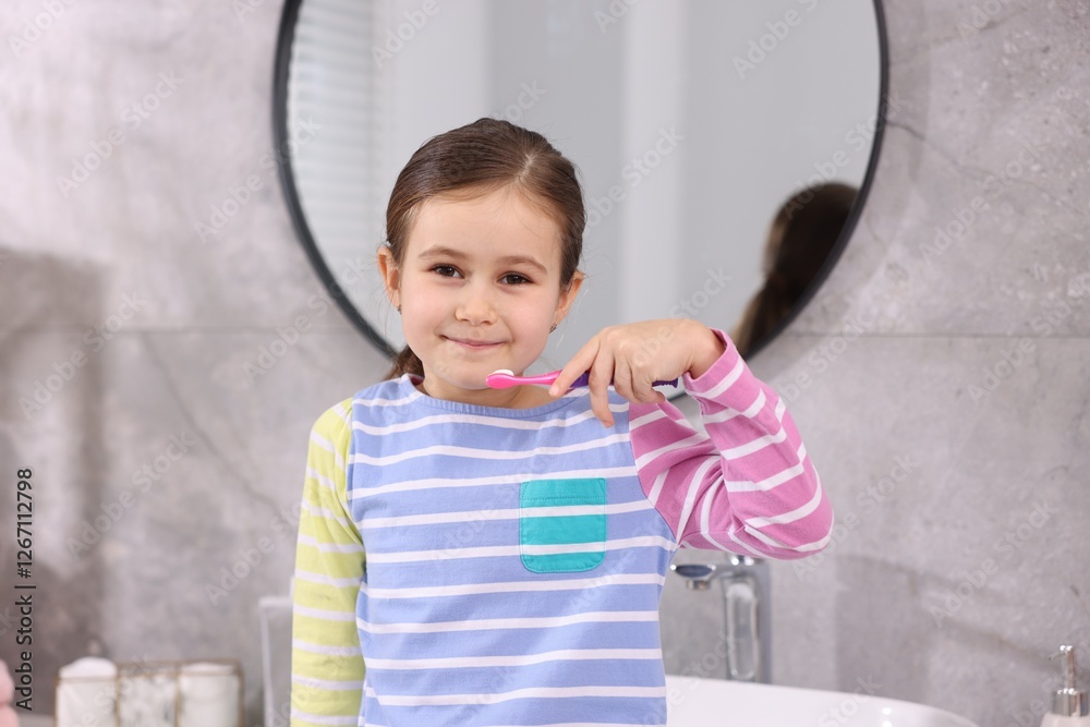 Fototapeta premium Cute girl with toothbrush in bathroom. Personal hygiene