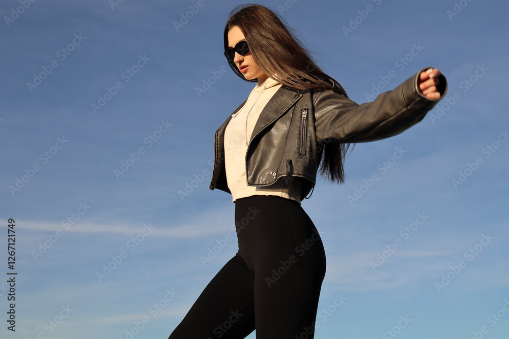 1 one alone beautiful young adult brunette latin latino hispanic woman with raised arms wear modern short stylish leather jacket sunglasses sexy black leggins. hands up. Free freedom concept idea 1 one alone beautiful young adult brunette latin latino hispanic woman with raised arms wear modern short stylish leather jacket sunglasses sexy black leggins. hands up. Free freedom concept idea