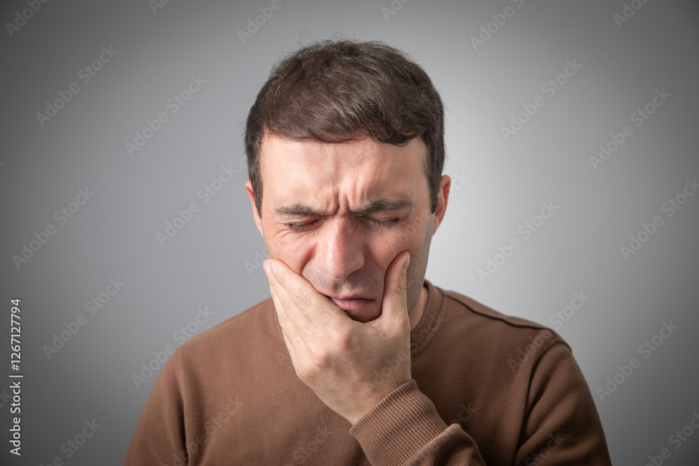 Caucasian man suffering from tooth pain. Caucasian man suffering from tooth pain.