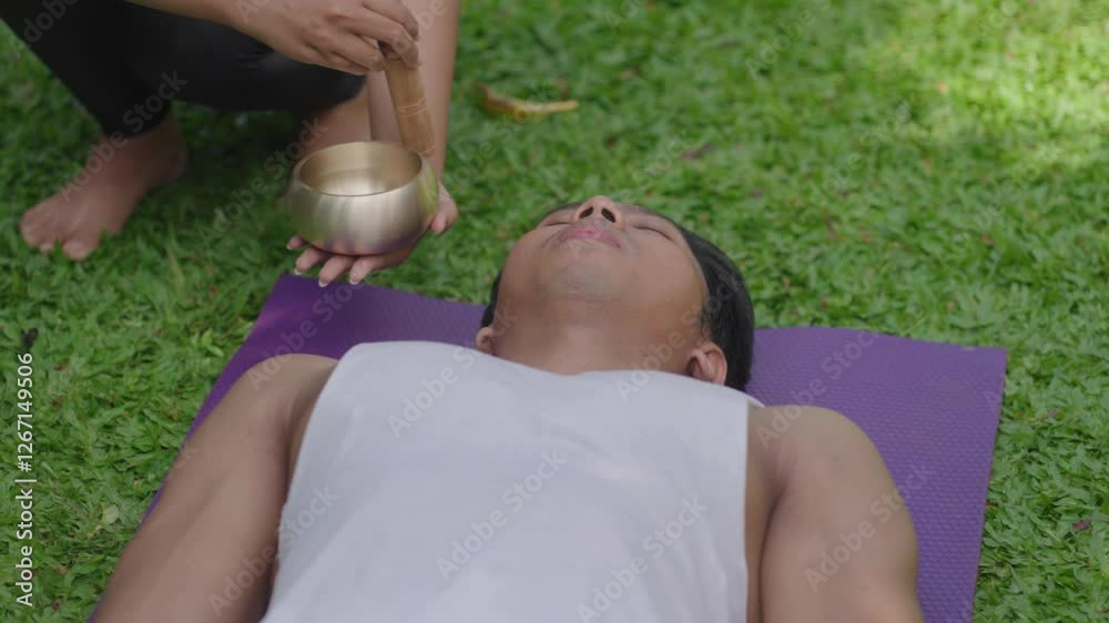Sound Healing with Singing Bowl Meditation Yoga Pose Movement On Beautiful Lush Garden Green Grass in Ubud Bali Indonesia Sound Healing with Singing Bowl Meditation Yoga Pose Movement On Beautiful Lush Garden Green Grass in Ubud Bali Indonesia