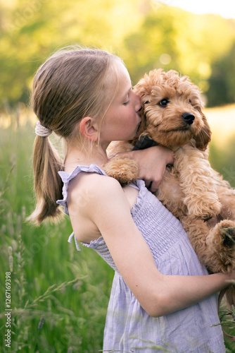 Girl with her cavapoo puppy in her arms