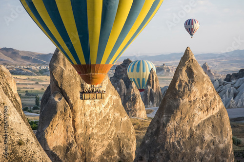 Quadro su tela Hot air balloons flying over volcanic rock formations and fairy chimneys in Capp
