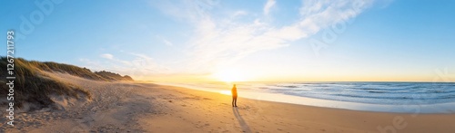 Serene beach sunset with a lone figure gazing at the horizon