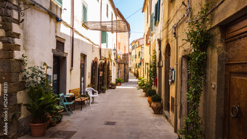 Fototapeta Naklejka Na Ścianę i Meble -  Typical tine italian streets somewhere in tuscany town of Scansano evokes peaceful and calm genius loci where you can retreat from the hustle during summer vacation in medieval town with slow life.