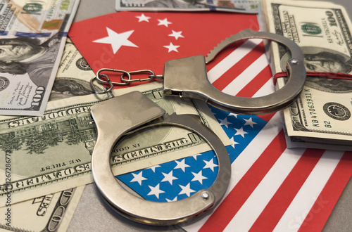 United States of America flag with handcuffs and a bundle of dollars. Currency corruption in the country. Financial crimes
