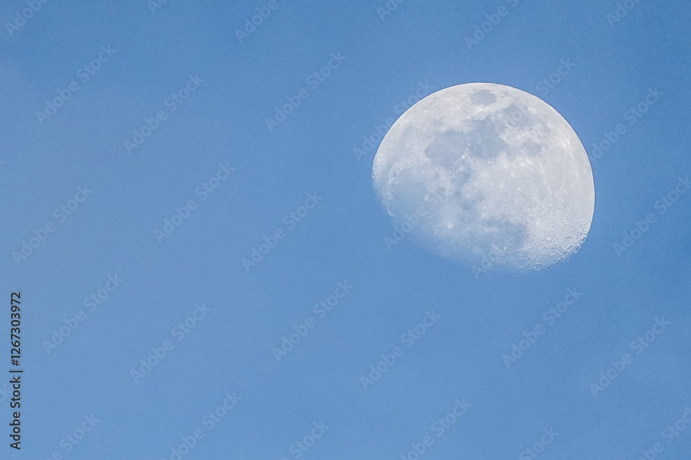 The moon in the daytime sky before dusk The moon in the daytime sky before dusk