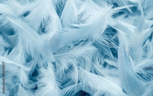 Ethereal light blue feathers floating in the air with a dreamy and soft abstract background creating a weightless and elegant atmosphere for delicate and luxurious designs