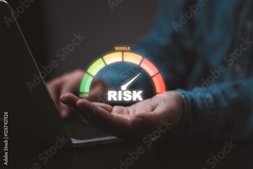 Businessman holding risk level indicator rating since low to high for Risk management and assessment concept.