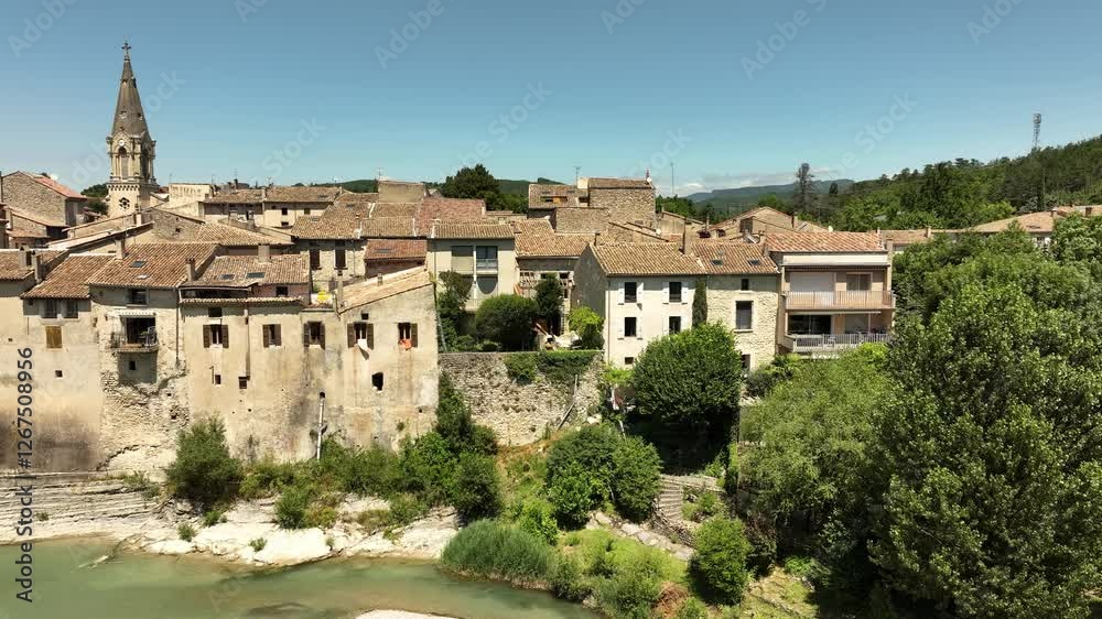 Aerial view from Southern France (village of Aouste-sur-Sye), view of village with church and bridge over the river Drome. Aerial view from Southern France (village of Aouste-sur-Sye), view of village with church and bridge over the river Drome.
