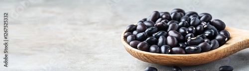 Wallpaper Mural Black beans in a wooden spoon, wholesome plant-based protein ingredient Torontodigital.ca