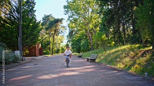 Wallpaper Mural Carefree kid cycling park alley having fun. Little child riding bicycle alone Torontodigital.ca