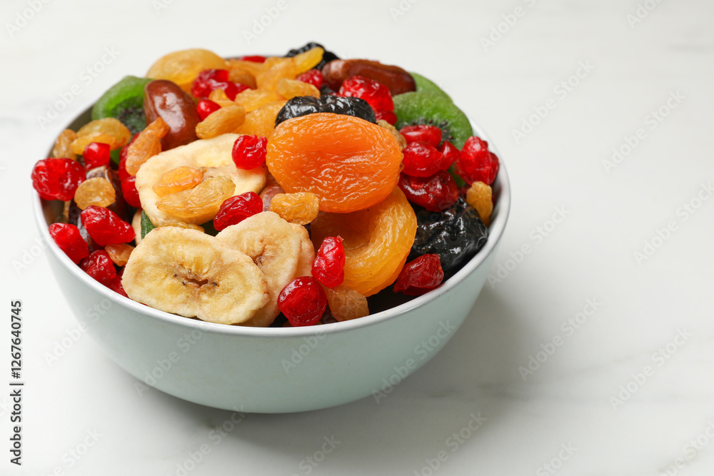 Mix of different dried fruits in bowl on white marble table, closeup Mix of different dried fruits in bowl on white marble table, closeup