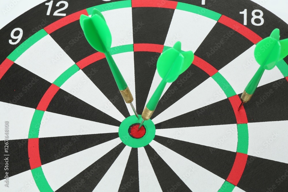 Dart board with green arrows on white background, closeup Dart board with green arrows on white background, closeup
