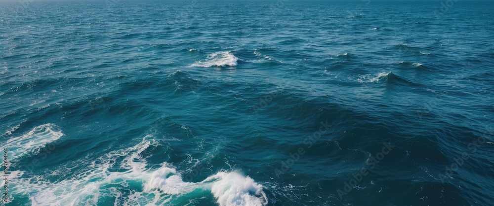Obraz premium Vast Blue Ocean Waves with Tranquil Water Surface and Ample Copy Space for Textual Content or Graphics.