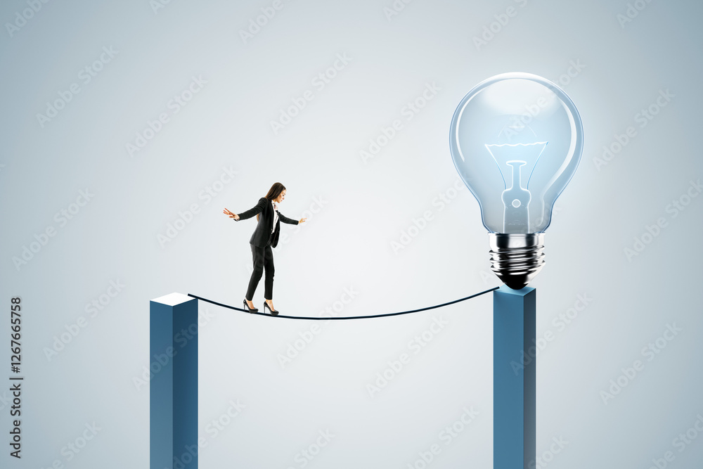 Businesswoman balancing on wire towards giant lightbulb. Businesswoman balancing on wire towards giant lightbulb.