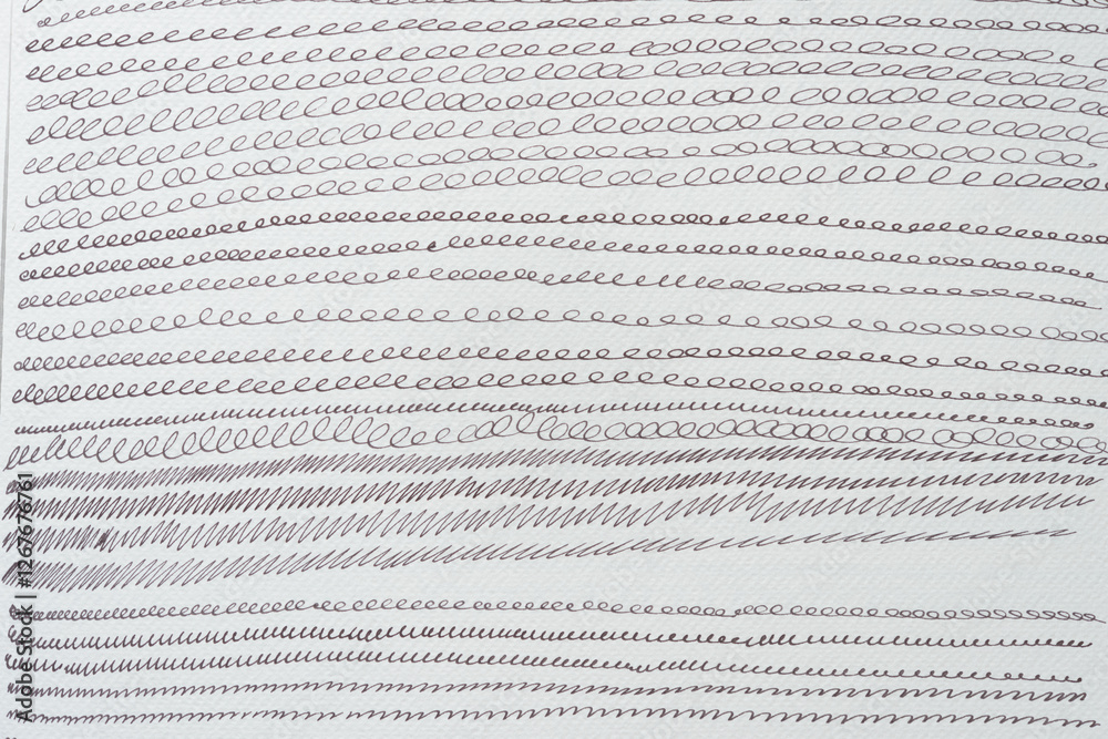 set of cursive or repeating looping lines on textured paper set of cursive or repeating looping lines on textured paper