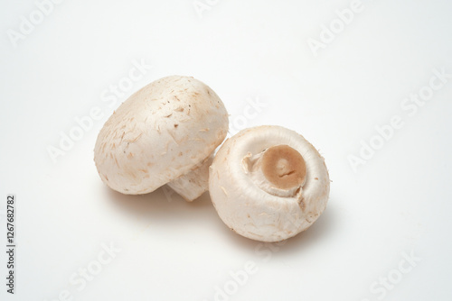 Whole champignons mushrooms on white background