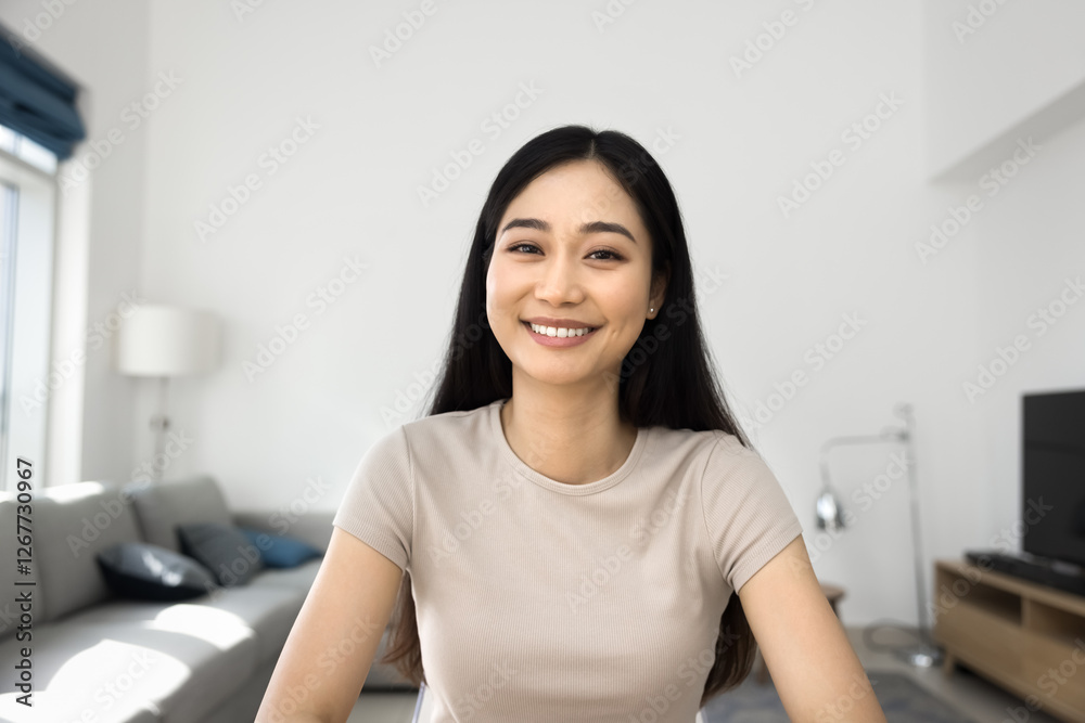 Head shot Asian woman sit indoors look at camera with positive, joyful expression. Profile picture of videoconference participant, smile, record video for vlog. Social media icon, influencer portrait Head shot Asian woman sit indoors look at camera with positive, joyful expression. Profile picture of videoconference participant, smile, record video for vlog. Social media icon, influencer portrait