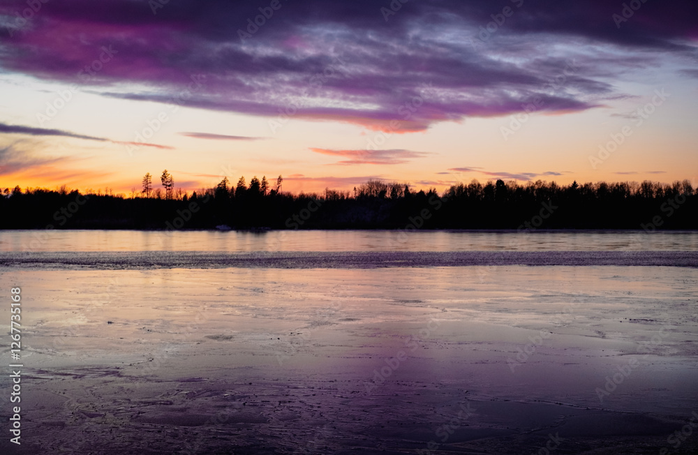 Fototapeta premium Scenic view of a lake at winter during evening