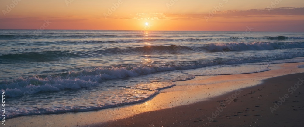 Fototapeta premium Sunset over tranquil ocean waves with sandy beach in foreground perfect for relaxation imagery and copy space for text