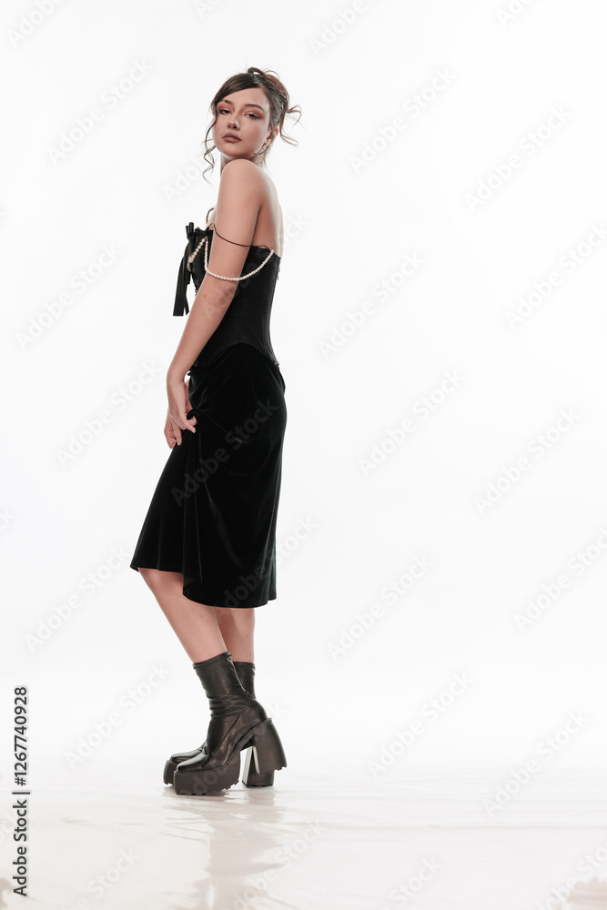 Young beautiful girl brunette of an eastern outbreak of black dress on a white background Young beautiful girl brunette of an eastern outbreak of black dress on a white background